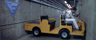 Austin Powers attempting to escape in a golf cart whilst being jammed in a corridor